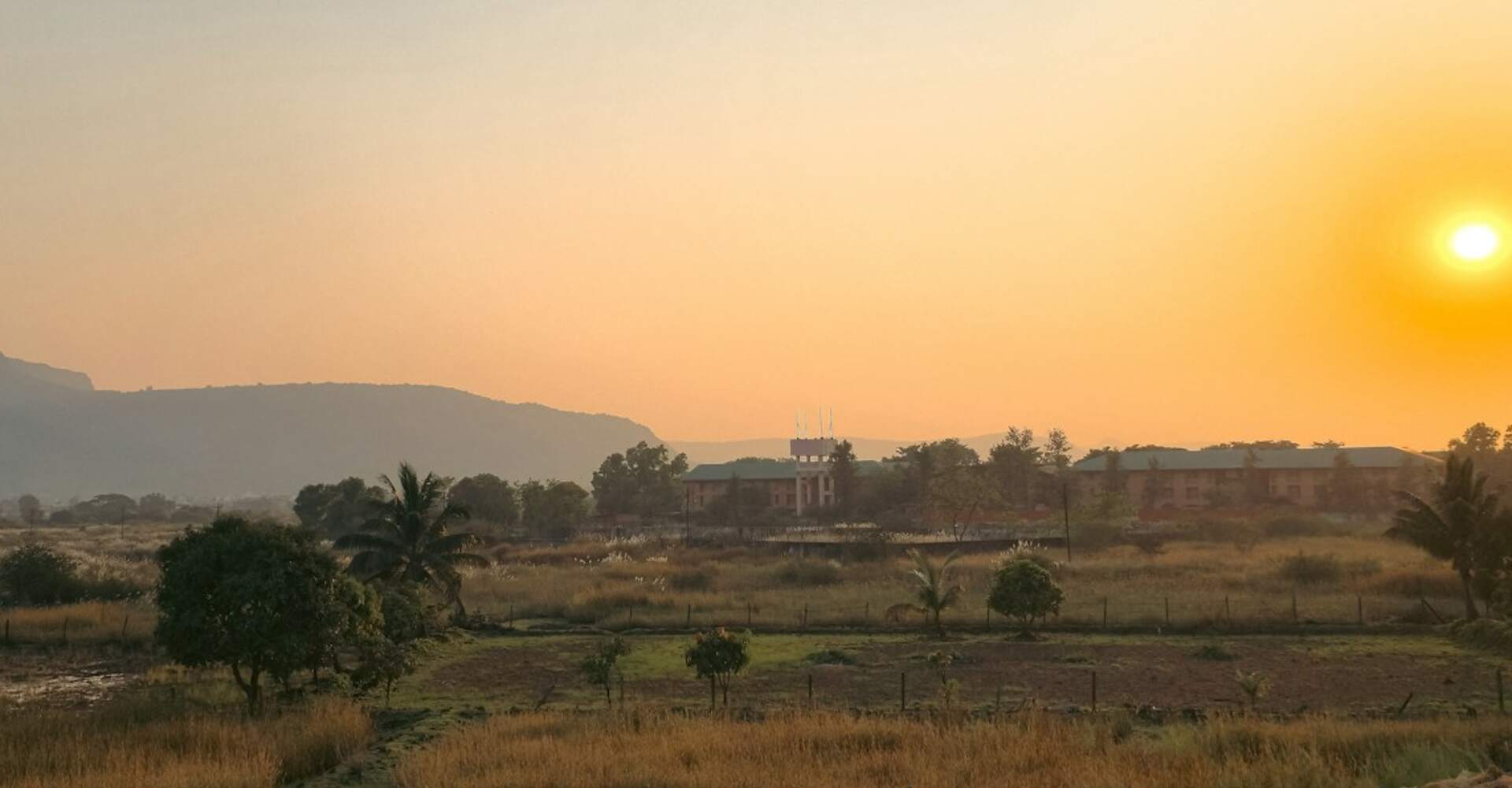 Sunset over open countryside in India