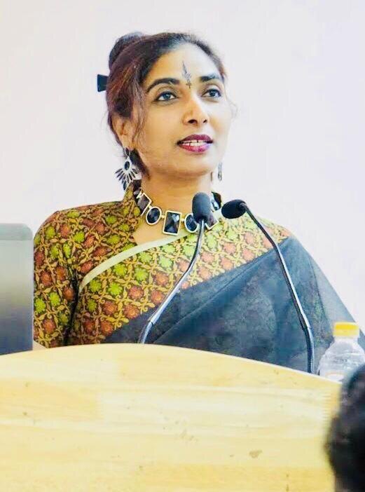 Prof. (Dr.) Meena Sharma speaking at a lectern