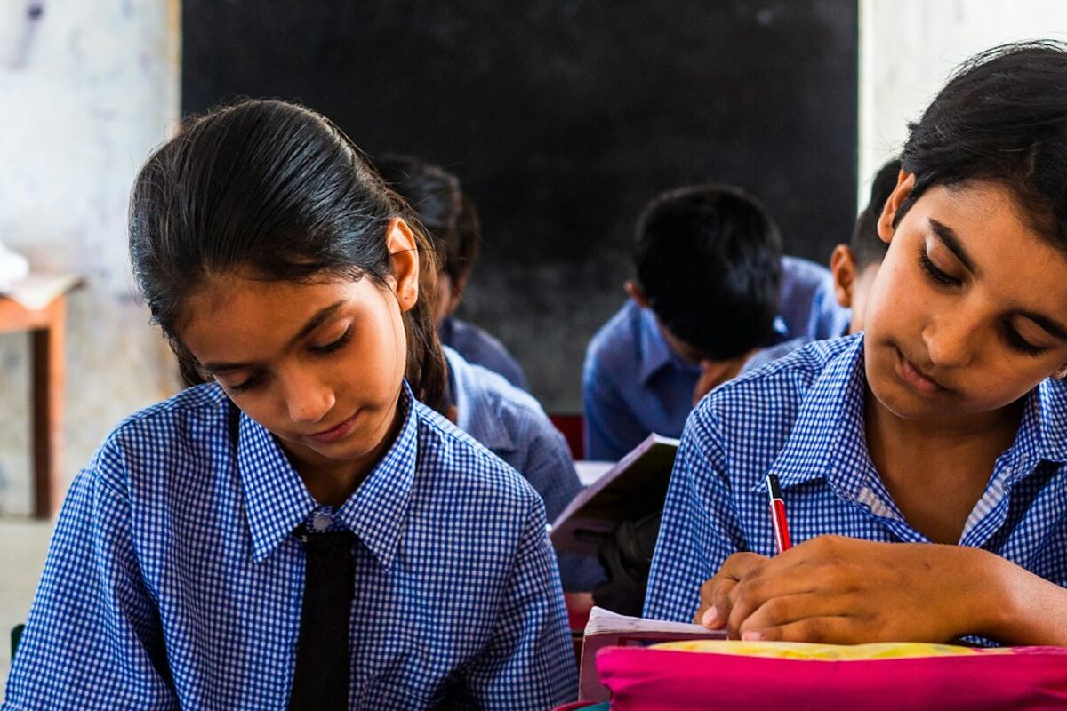 Two schoolgirls studying at a desk