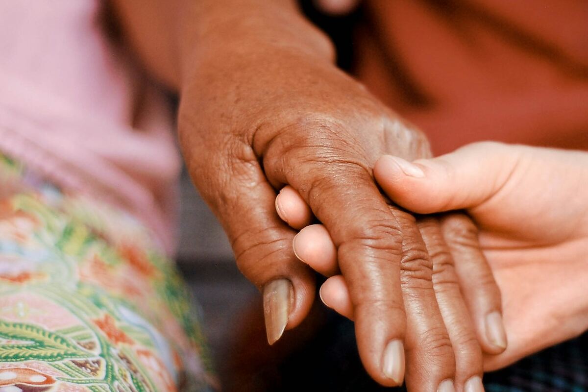Two hands held together in a gesture of support